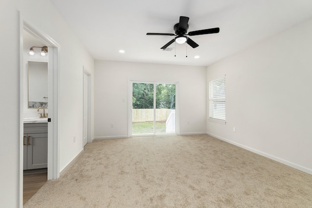 509 W Sixth St, Brenham, TX 77833 - empty room with ceiling fan, a sink, baseboards, carpet floors, and recessed lighting