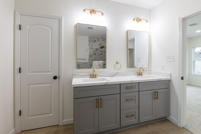 509 W Sixth St, Brenham, TX 77833 - full bath featuring double vanity, wood finished floors, and baseboards