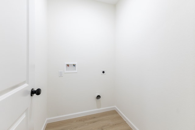 509 W Sixth St, Brenham, TX 77833 - laundry room with electric dryer hookup, washer hookup, light wood finished floors, and baseboards