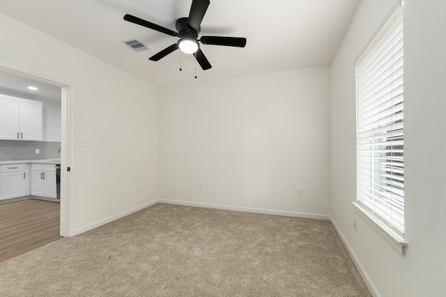509 W Sixth St, Brenham, TX 77833 - empty room with light colored carpet, a ceiling fan, and baseboards