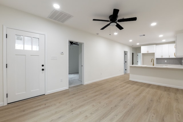 509 W Sixth St, Brenham, TX 77833 - unfurnished living room with light wood-style floors, a sink, ceiling fan, recessed lighting, and baseboards