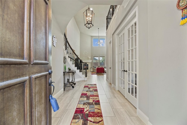 3310 Ralston Edge Ln, Houston, TX 77059 - foyer featuring a chandelier, stairway, french doors, baseboards, and a towering ceiling