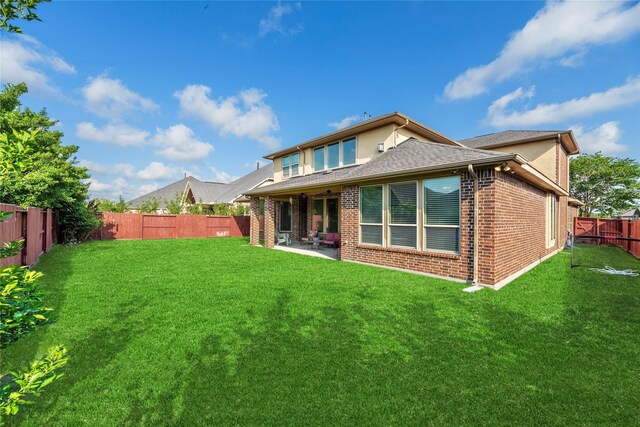 3310 Ralston Edge Ln, Houston, TX 77059 - back of property featuring brick siding, a patio area, and roof with shingles
