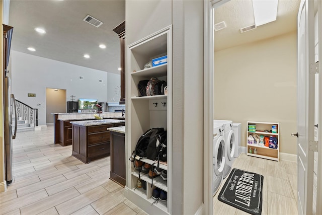3310 Ralston Edge Ln, Houston, TX 77059 - laundry room with separate washer and dryer, wood finish floors, and recessed lighting