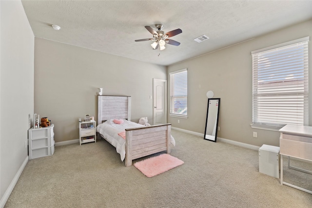 3310 Ralston Edge Ln, Houston, TX 77059 - bedroom featuring light carpet, baseboards, a ceiling fan, and a textured ceiling