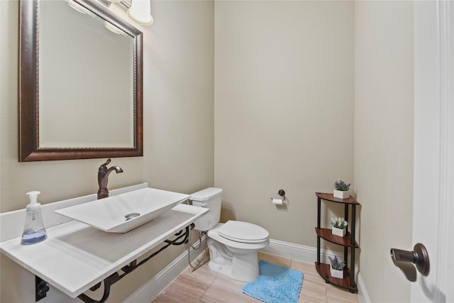 3310 Ralston Edge Ln, Houston, TX 77059 - half bathroom with a sink, toilet, and baseboards