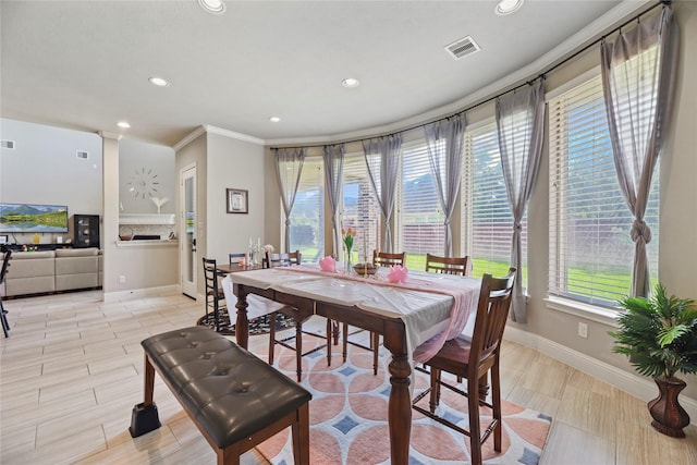 3310 Ralston Edge Ln, Houston, TX 77059 - dining room featuring recessed lighting, plenty of natural light, ornamental molding, and a fireplace