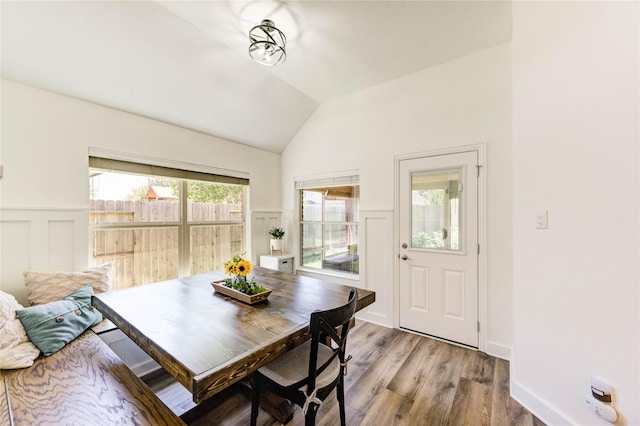 12006 Bright Landing Ct, Pearland, TX 77584 - dining room with a wainscoted wall, wood finished floors, vaulted ceiling, and a decorative wall
