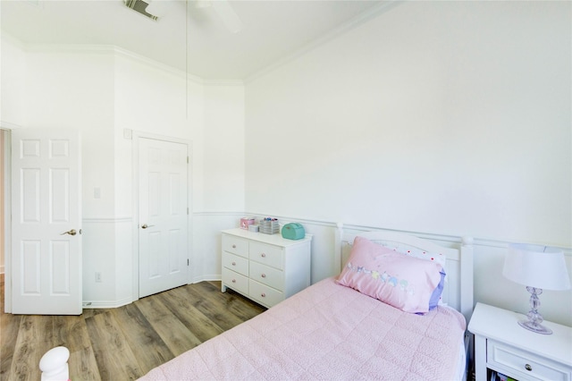 12006 Bright Landing Ct, Pearland, TX 77584 - bedroom with wood finished floors and crown molding