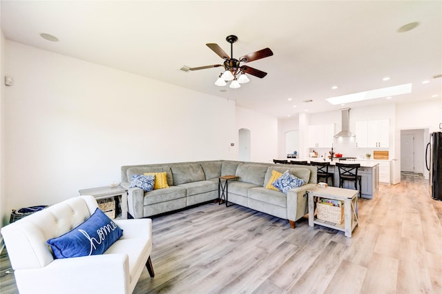 12006 Bright Landing Ct, Pearland, TX 77584 - living room with light wood-style floors, a ceiling fan, recessed lighting, and arched walkways