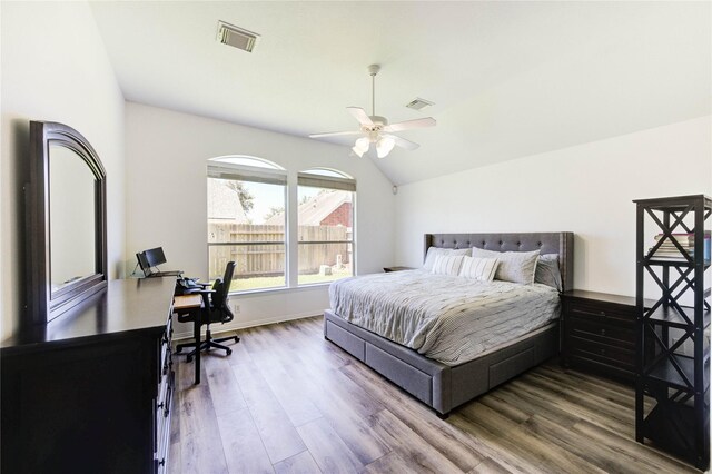 12006 Bright Landing Ct, Pearland, TX 77584 - bedroom with an office area, wood finished floors, vaulted ceiling, a ceiling fan, and baseboards