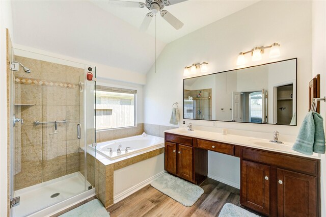 12006 Bright Landing Ct, Pearland, TX 77584 - bathroom with a bath, vaulted ceiling, a shower stall, double vanity, and wood finished floors