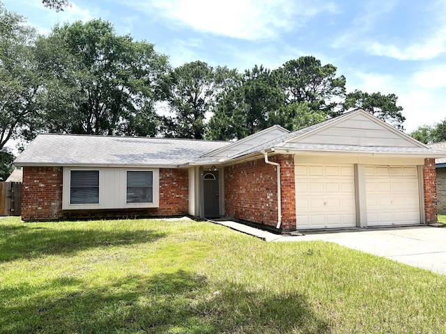 21007 Rivershadows Ln, Spring, TX 77388 - ranch-style home with a garage, brick siding, a front yard, and driveway