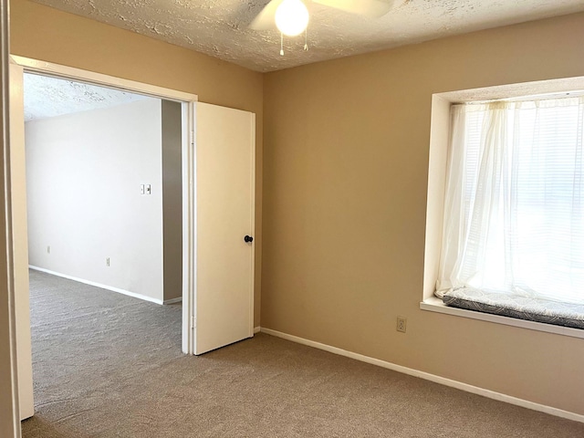 21007 Rivershadows Ln, Spring, TX 77388 - spare room with carpet flooring, a textured ceiling, baseboards, and ceiling fan
