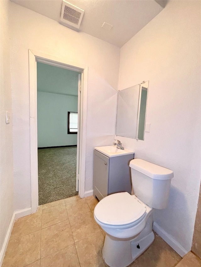 6802 Crestridge St, Houston, TX 77033 - bathroom with vanity, toilet, baseboards, and tile patterned floors