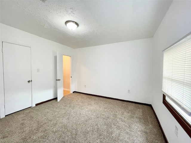 6802 Crestridge St, Houston, TX 77033 - unfurnished bedroom featuring carpet floors, baseboards, and a textured ceiling