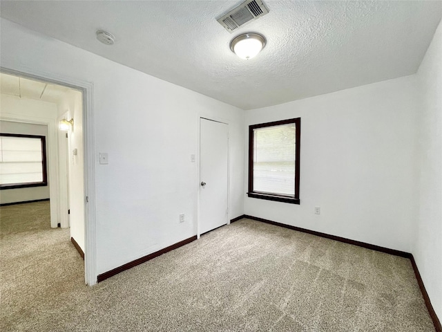 6802 Crestridge St, Houston, TX 77033 - unfurnished bedroom with carpet flooring, a textured ceiling, baseboards, and a closet