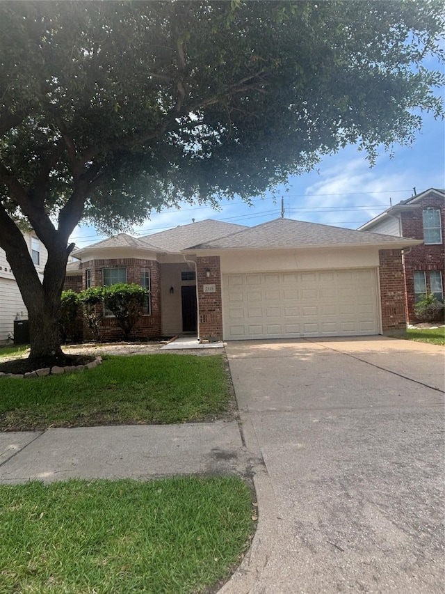 7415 Bering Landing Dr, Cypress, TX 77433 - single story home featuring an attached garage, brick siding, and driveway