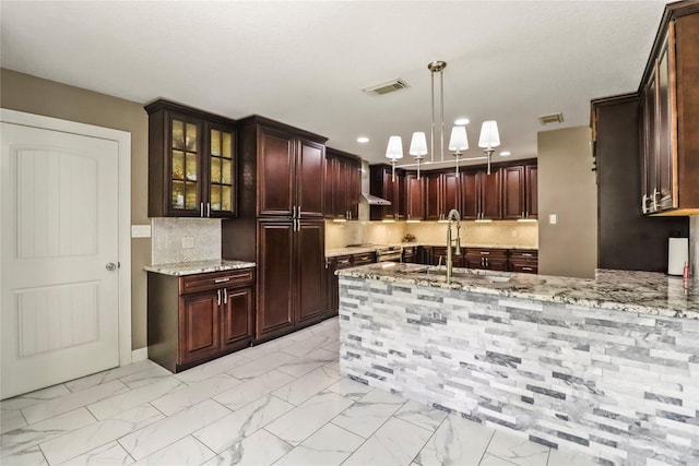 37 N Erik Dr, Angleton, TX 77515 - kitchen with light stone countertops, light marble finish floors, glass insert cabinets, tasteful backsplash, and hanging light fixtures