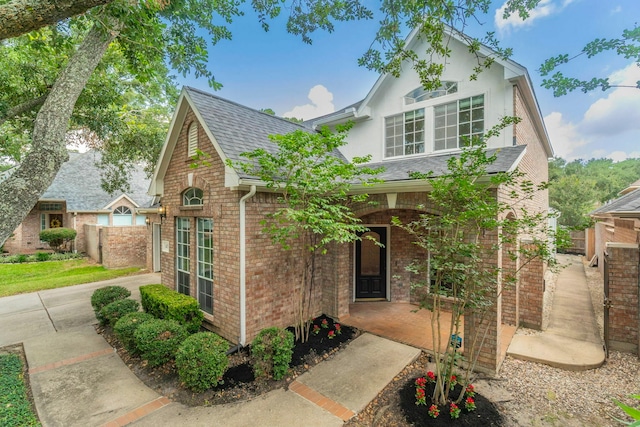 5407 Lake Place Dr, Houston, TX 77041 - view of front of house with roof with shingles, brick siding, and covered porch