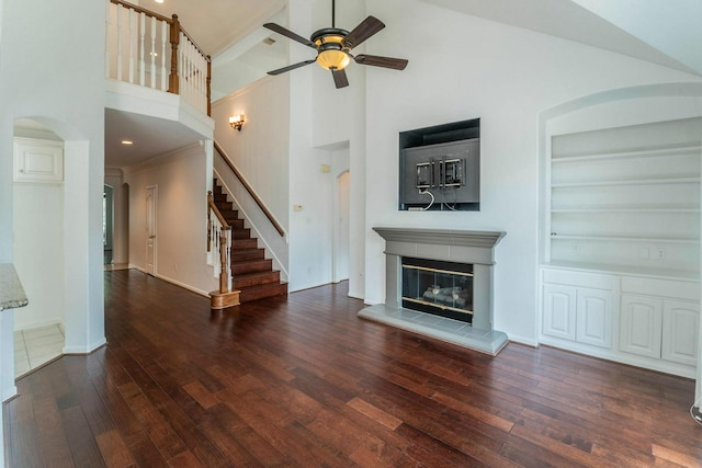5407 Lake Place Dr, Houston, TX 77041 - unfurnished living room with arched walkways, high vaulted ceiling, a ceiling fan, wood-type flooring, and built in shelves