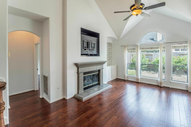 5407 Lake Place Dr, Houston, TX 77041 - unfurnished living room featuring arched walkways, ceiling fan, wood-type flooring, high vaulted ceiling, and built in features
