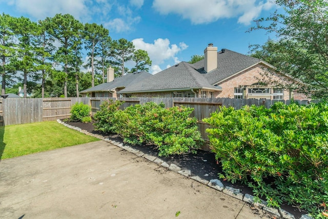 5407 Lake Place Dr, Houston, TX 77041 - back of property with a patio, a chimney, roof with shingles, and brick siding