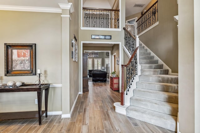 16342 Granite Park Ct, Cypress, TX 77429 - foyer with wood finished floors, decorative columns, stairs, baseboards, and crown molding