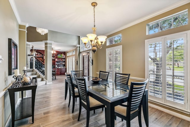 16342 Granite Park Ct, Cypress, TX 77429 - dining area with a chandelier, ornate columns, crown molding, light wood finished floors, and baseboards