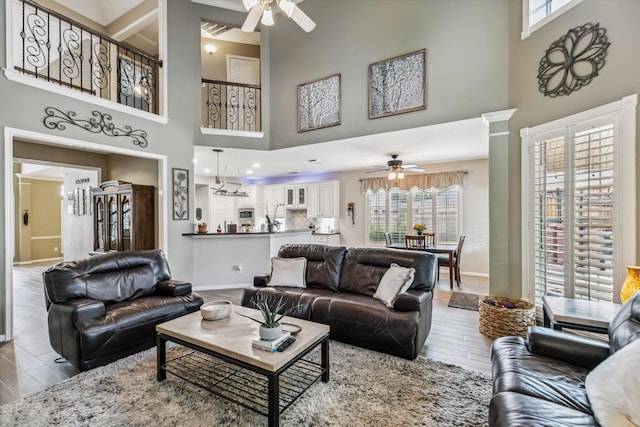 16342 Granite Park Ct, Cypress, TX 77429 - living area featuring ceiling fan, a high ceiling, wood finished floors, and plenty of natural light