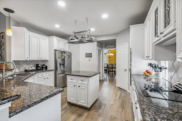 16342 Granite Park Ct, Cypress, TX 77429 - kitchen featuring stainless steel refrigerator with ice dispenser, a sink, black electric stovetop, white cabinetry, and recessed lighting