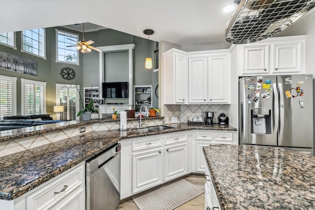 16342 Granite Park Ct, Cypress, TX 77429 - kitchen with stainless steel appliances, a sink, ceiling fan, open floor plan, and white cabinets