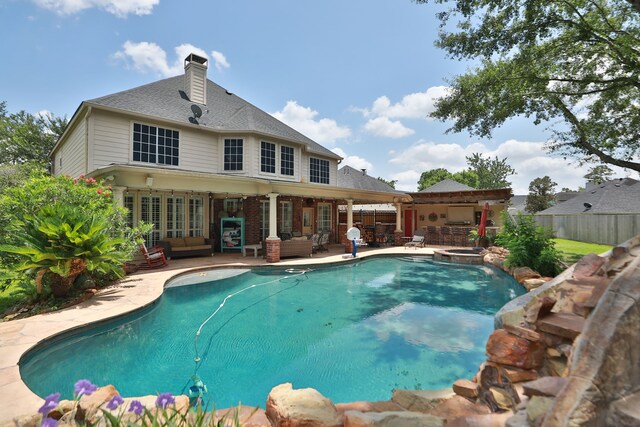 16342 Granite Park Ct, Cypress, TX 77429 - view of swimming pool with an outdoor living space, a patio, french doors, and a pool with connected hot tub