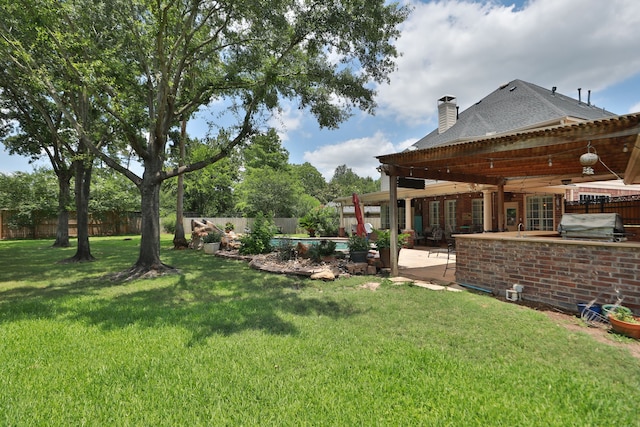 16342 Granite Park Ct, Cypress, TX 77429 - view of yard featuring a patio area and an outdoor kitchen