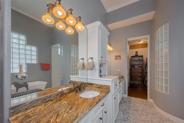 12214 Francel Ln, Cypress, TX 77429 - full bathroom featuring vanity, a freestanding bath, a spacious closet, ornamental molding, and a chandelier