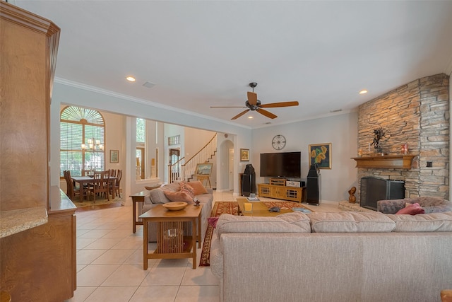 12214 Francel Ln, Cypress, TX 77429 - living room featuring stairway, light tile patterned flooring, a stone fireplace, a ceiling fan, and ornamental molding