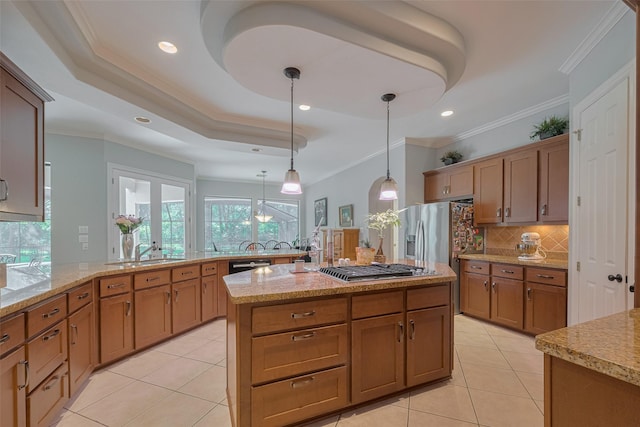 12214 Francel Ln, Cypress, TX 77429 - kitchen featuring tasteful backsplash, light tile patterned flooring, light stone countertops, hanging light fixtures, and ornamental molding