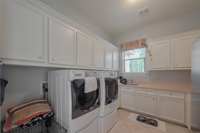 12214 Francel Ln, Cypress, TX 77429 - washroom featuring cabinet space, washer and dryer, and light tile patterned flooring