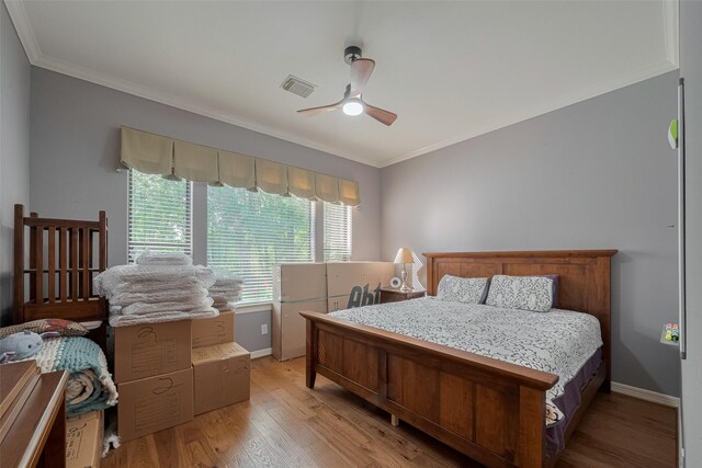 12214 Francel Ln, Cypress, TX 77429 - bedroom with crown molding, light wood-style flooring, and a ceiling fan