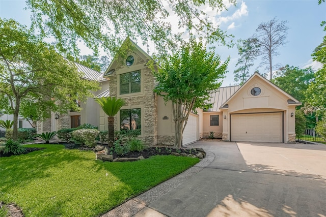 12214 Francel Ln, Cypress, TX 77429 - view of front of house with a standing seam roof, stone siding, a garage, and concrete driveway