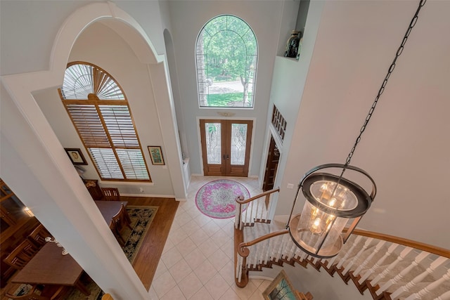 12214 Francel Ln, Cypress, TX 77429 - entryway featuring french doors, a towering ceiling, tile patterned flooring, arched walkways, and a chandelier