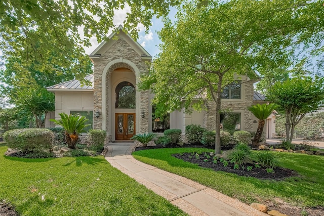 12214 Francel Ln, Cypress, TX 77429 - view of front of home featuring a standing seam roof, stone siding, french doors, and a front yard