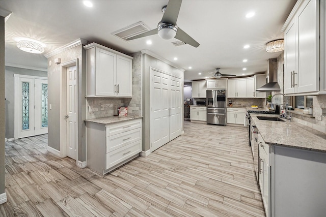 1510 Apple Park Dr, Katy, TX 77450 - kitchen with wall chimney exhaust hood, ceiling fan, ornamental molding, stainless steel appliances, and backsplash