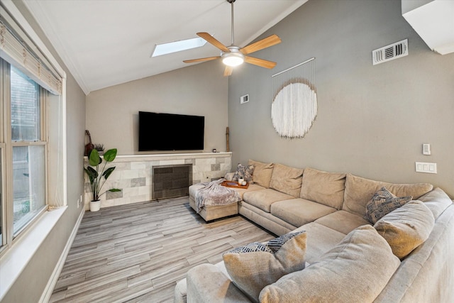 1510 Apple Park Dr, Katy, TX 77450 - living room featuring lofted ceiling, ceiling fan, wood finished floors, a skylight, and baseboards