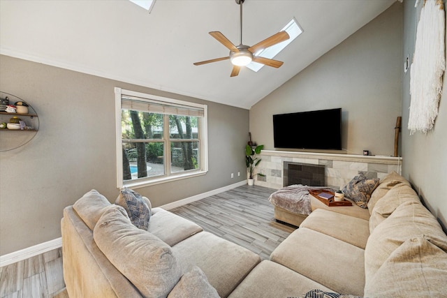 1510 Apple Park Dr, Katy, TX 77450 - living area featuring ceiling fan, wood finished floors, baseboards, a skylight, and high vaulted ceiling