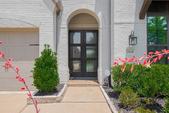 29118 Sage Trace Ct, Fulshear, TX 77441 - property entrance featuring french doors, brick siding, and a garage