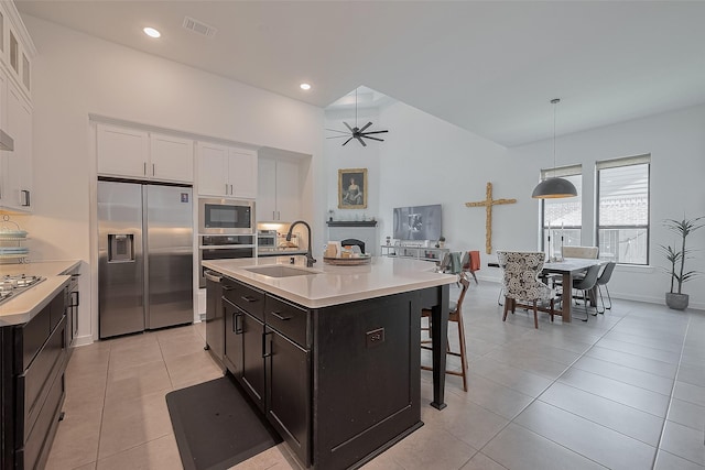 29118 Sage Trace Ct, Fulshear, TX 77441 - kitchen featuring stainless steel appliances, a sink, light countertops, white cabinets, and recessed lighting