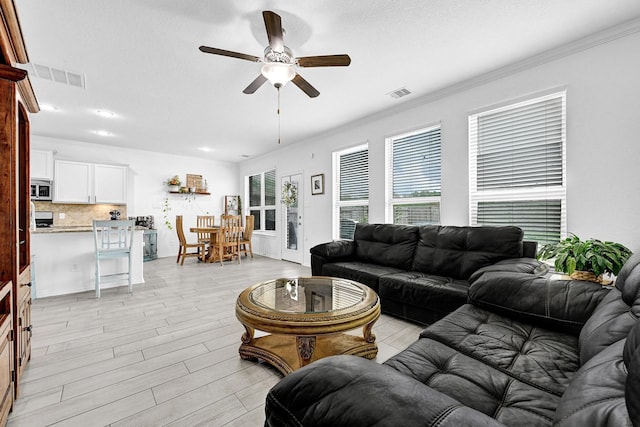 1362 Tee Time Ct, Crosby, TX 77532 - living area with ceiling fan, ornamental molding, light wood-style flooring, and recessed lighting