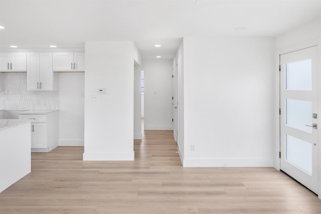 971 Mary Ann, Crystal Beach, TX 77650 - kitchen with recessed lighting, white cabinets, light wood-style flooring, baseboards, and tasteful backsplash