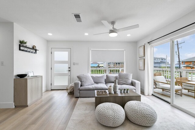 971 Mary Ann, Crystal Beach, TX 77650 - living room featuring plenty of natural light, a ceiling fan, light wood-type flooring, recessed lighting, and baseboards